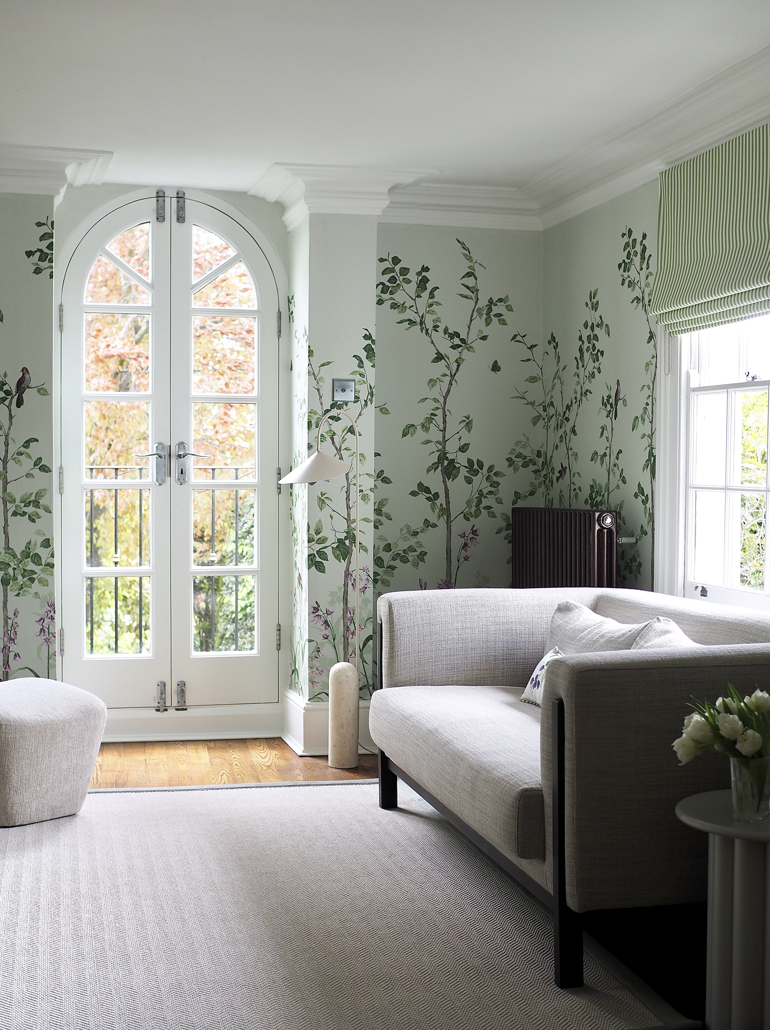 Green botanical wallpaper in a sophisticated living room